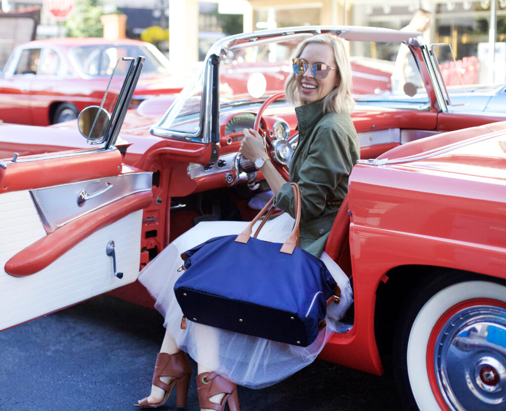 Jemma Bag featured by top US fashion blog, Lombard and Fifth: image of a blonde woman with a Birdie Jemma bag, a Madewell military jacket, and a J Crew striped top