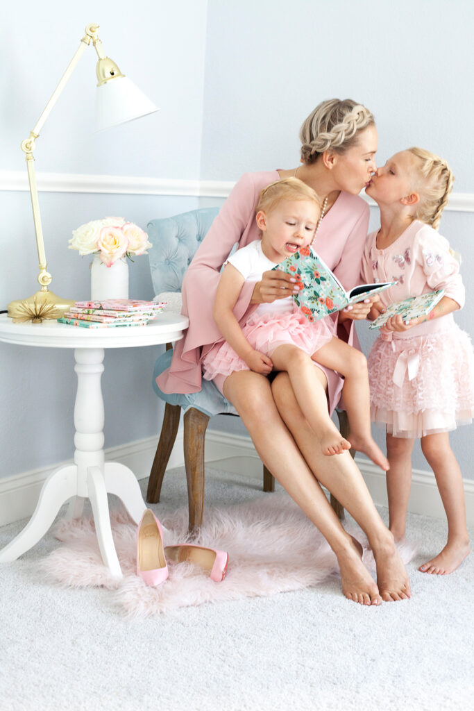 Rifle Paper Co for Chatbooks' floral prints featured by top US life and style blog, Lombard & Fifth: image of a mom and her 2 girls looking at a Chatbooks photo album
