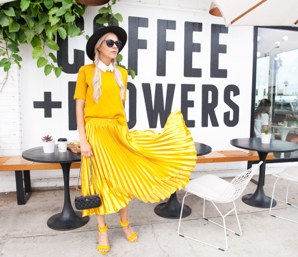 Marigold trend featured by top US fashion blog, Lombard and Fifth: image of a blonde woman wearing a Zara short sleeve sweater, an Anthropologies maxi skirt, TOPSHOP sandals and a Lack of Color wide brim hat