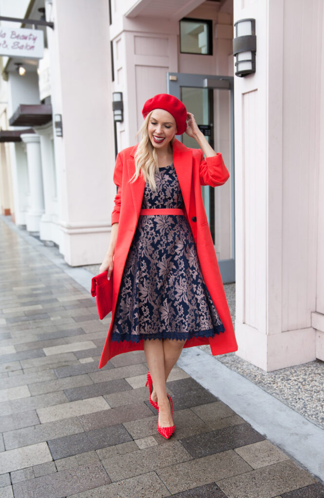 Valentine’s Day dress featured by top US fashion blog, Lombard and Fifth: image of a blonde woman wearing a Review Australia floral dress, ASOS red coat, Urban Outfitters red beret and an Anthropologie clutch