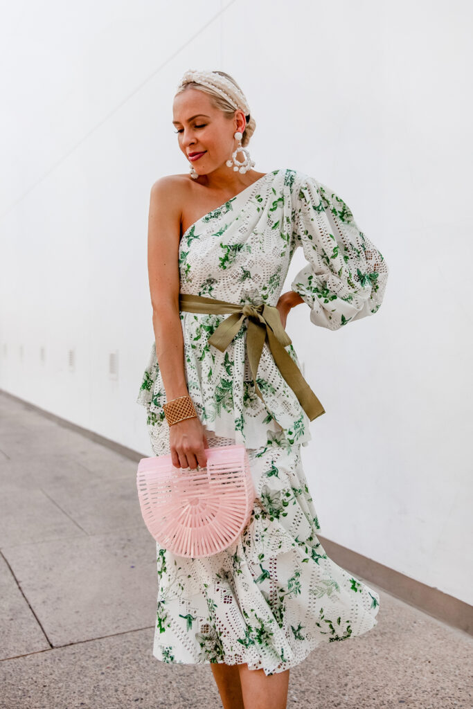 Stylish Special Occasion Dresses for Summer featured by top US fashion blog, Lombard and Fifth: image of a woman wearing Red Dress Boutique statement earrings, ASOS one shoulder dress, Cult Gaia mini ark bag, pearl headband, and Schutz sandals