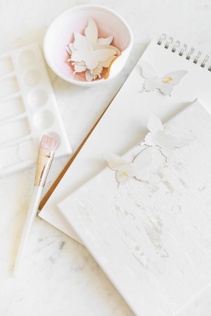 How to update your wall décor with a simple DIY paper butterfly painting, featured by San Francisco style blogger Lombard and Fifth.