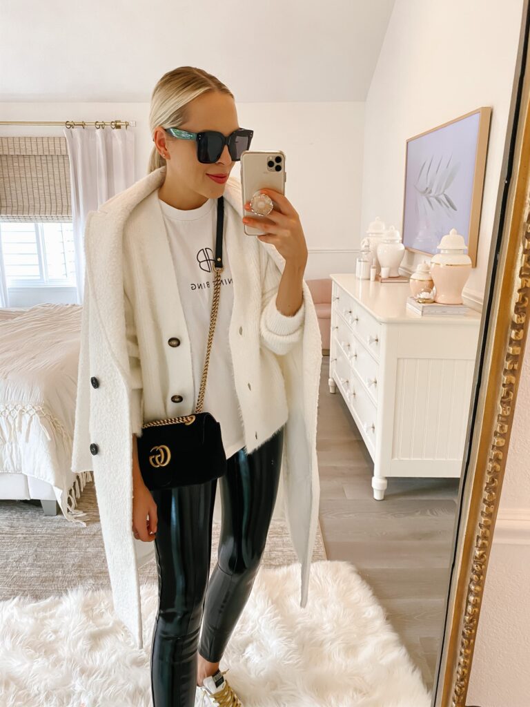 How to style casual chic layers and leggings for winter, by fashion blogger Lombard & Fifth. Express Sherpa white coat, commando leather leggings, Anine Bing sweatshirt, camel coat.