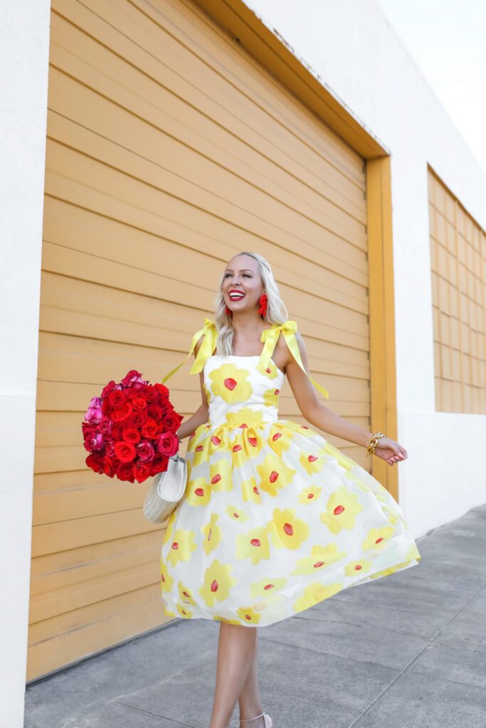 Independent designer spotlight, MAE Karalena yellow bow dress red roses, featured by Lombard & Fifth Veronica Levy. Small business feature, feminine fashion made in NYC.