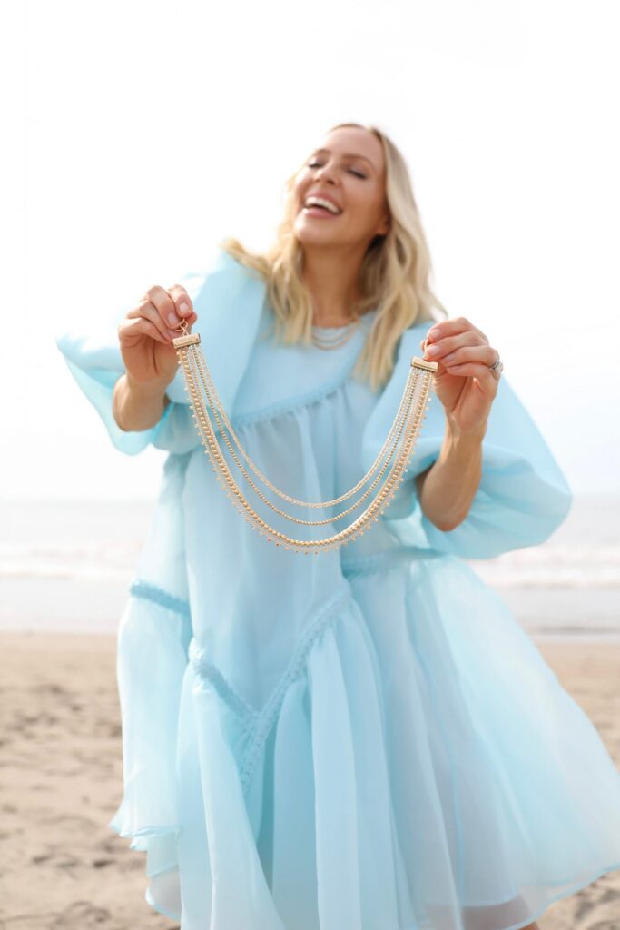 Victoria Emerson necklace collection by Veronica Levy, Lombard & Fifth. Aje light blue dress on the beach, gold jewelry style inspiration.