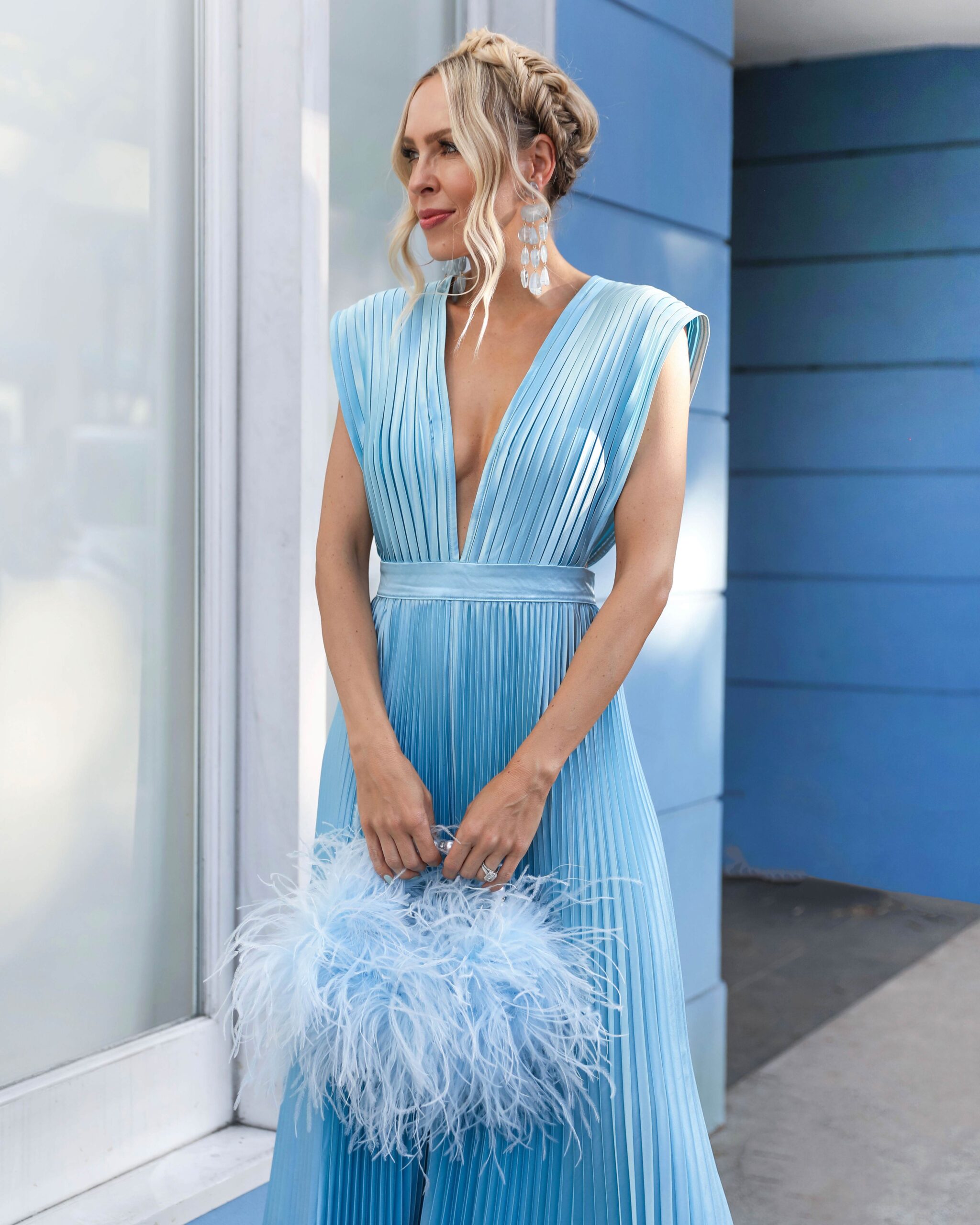 revolve light blue pleated jumpsuit. wedding guest style. Feather bag
