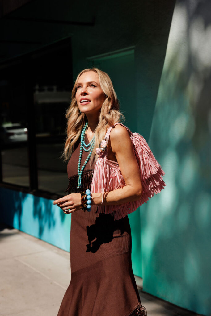 Close-up of fringe handbag and fringe dress texture highlighting the movement-focused Summer 2026 fashion trend.