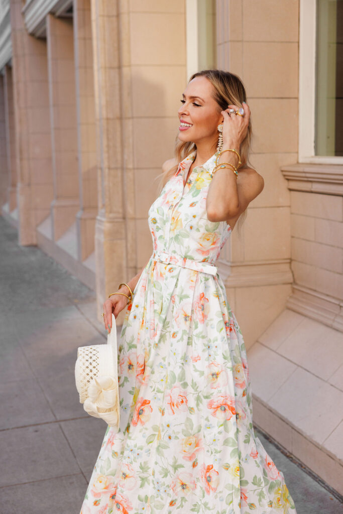 Summer garden party style with a floral dress, straw hat, and statement jewelry