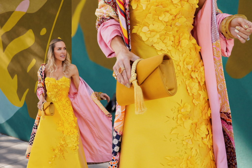 Marigold yellow floral appliqué dress styled with a Tuckernuck Gabrielle clutch for a statement fall fashion look.