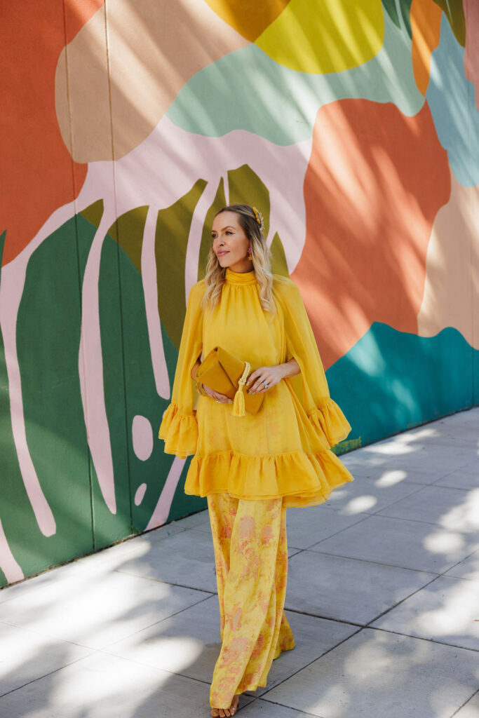 Marigold yellow floral appliqué dress styled with a Tuckernuck Gabrielle clutch for a statement fall fashion look.